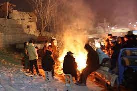 People in China surround a bonfire to beat the sub zero temperatures